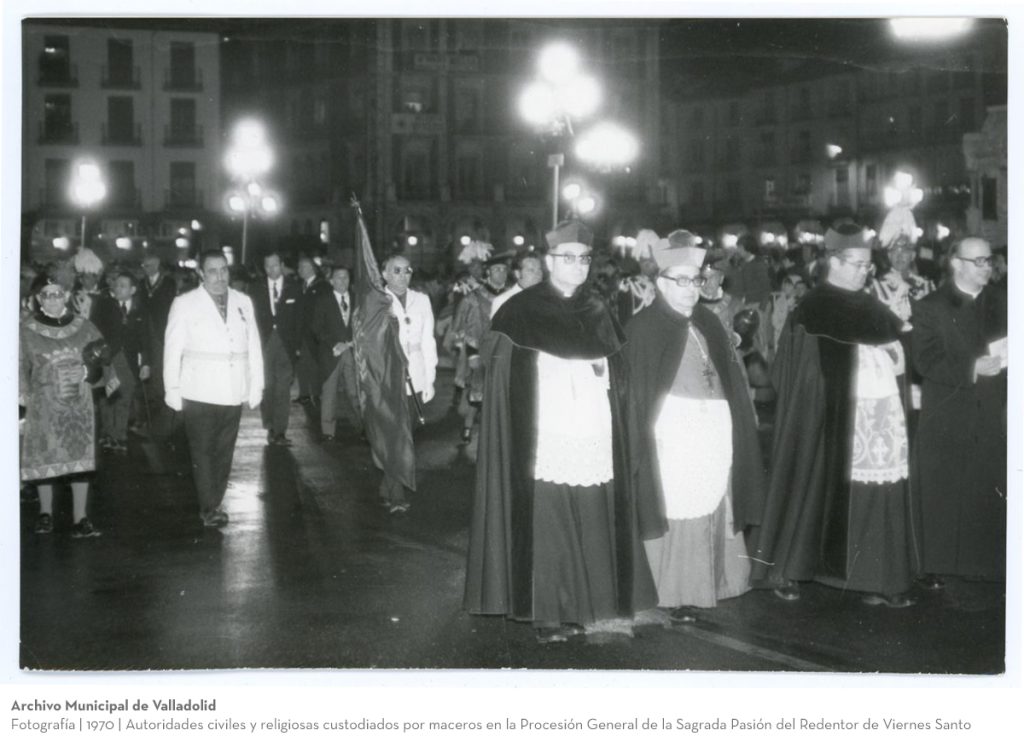 Fotografía. 1970. Autoridades civiles y religiosas custodiados por maceros en la Procesión General de la Sagrada Pasión del Redentor de Viernes Santo